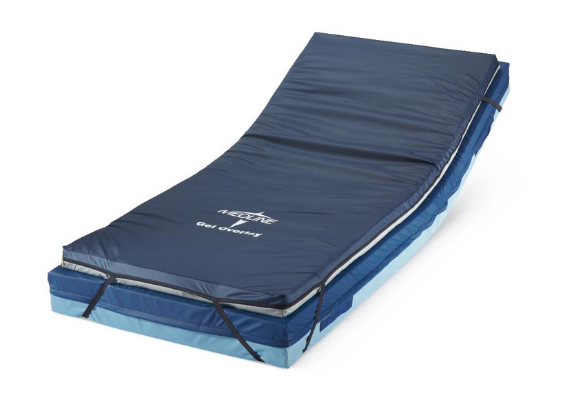 The Medline Standard Gel Foam Mattress Overlay features a blue design with an angled raised segment for reclining support. Its foam top layer provides comfort, while black straps keep the overlay securely in place for patients.